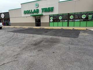 Close-up of repaired asphalt patch over cracked area